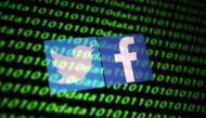 The Twitter and Facebook logo along with binary cyber codes are seen in this illustration taken November 26, 2019. REUTERS/Dado Ruvic/Illustration/File Photo