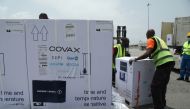 Workers offload boxes of AstraZeneca/Oxford vaccines as the country receives its first batch of coronavirus disease (COVID-19) vaccines under COVAX scheme, in Abidjan, Ivory Coast February 26, 2021. REUTERS/Luc Gnago