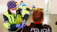 A police officer receives his first dose of the AstraZeneca COVID-19 vaccine, as the coronavirus disease (COVID-19) outbreak continues, at Atletico Madrid's Wanda Metropolitano stadium in Madrid, Spain, February 25, 2021. REUTERS/Sergio Perez/File Photo