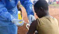 FILE PHOTO: A Congolese health worker administers Ebola vaccine to a boy who had contact with an Ebola sufferer in the village of Mangina in North Kivu province of the Democratic Republic of Congo, August 18, 2018. REUTERS/Olivia Acland//File Photo

