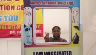  A woman poses for a picture with a cardboard cutout after receiving a dose of COVISHIELD, a COVID-19 vaccine manufactured by Serum Institute of India, at a vaccination centre, after second wave of vaccination started for the elderly with comorbidities, a