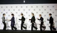 Members of K-pop boy band BTS pose for photographs during a news conference promoting their new album 