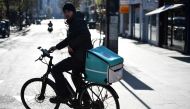 A courier for food delivery service Deliveroo rides a bike, as as the spread of the coronavirus disease (COVID-19) continues, in London, Britain, March 24, 2020. REUTERS/Dylan Martinez/File Photo