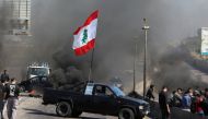 A vehicle blocks a road during a protest against the fall in Lebanese pound currency and mounting economic hardships in Khaldeh, Lebanon March 8, 2021. REUTERS/Mohamed Azakir