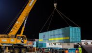 GAC Qatar staff unloading containers at Losail Circuit Sports Club.