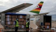 FILE PHOTO: Workers offload boxes as the country's first batch of coronavirus disease (COVID-19) vaccines arrives from China, in Harare, Zimbabwe, February 15,2021. REUTERS/Philimon Bulawayo/File Photo
