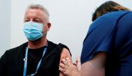 A healthcare professional administers a dose of the Pfizer coronavirus disease (COVID-19) vaccine to Dr. Chris Quinn as high-risk workers receive the first vaccines in the state of Victoria's rollout of the program, in Melbourne, Australia, February 22, 2