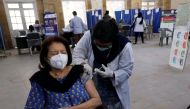 A woman receives the first dose of the coronavirus disease (COVID-19) vaccine, as the government started vaccination for the general public, starting with elderly people, at a vaccination center in Karachi, Pakistan March 10, 2021. REUTERS/Akhtar Soomro
