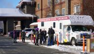 FILE PHOTO: Support workers for the Iditarod Trail Sled Dog Race line up outside the Lakefront ANCHORAGE Hotel, the site of the temporary ANCHORAGE Iditarod headquarters, to be tested for coronavirus (COVID-19), in ANCHORAGE, Alaska, U.S., March 4, 2021. 