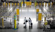 Passengers wearing hazmat suits for protection against the coronavirus disease (COVID-19) walk inside the Ninoy Aquino International Airport in Paranaque, Metro Manila, Philippines, January 14, 2021. REUTERS/Eloisa Lopez/File Photo