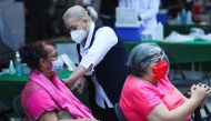 A woman receives the Pfizer-BioNTech coronavirus disease (COVID-19) vaccine during a mass vaccination in Mexico City, Mexico March 10, 2021. Reuters/Henry Romero