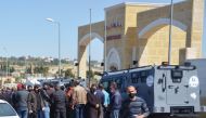 People gather outside the new Salt government hospital in the city of Salt, Jordan March 13, 2021. REUTERS/Muath Freij 