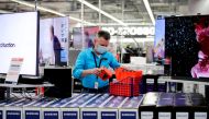 File photo: An employee wearing a protective mask works at a Saturn electronic store as the coronavirus disease (COVID-19) lockdown measures are eased in Berlin, Germany, March 11, 2021. Reuters/Hannibal Hanschke/File Photo