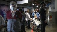 Elderly citzens wait in line to receive the Sinovac's CoronaVac coronavirus disease (COVID-19) vaccine during the mass vaccination program for the elderly people at Movistar Arena in Bogota, Colombia March 9, 2021. Picture taken March 9, 2021. REUTERS/Lui