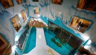 Visitors look at polar bears at an enclosure inside a hotel at a newly-opened polarland-themed park in Harbin, capital of northeast China's Heilongjiang province March 12, 2021. Picture taken March 12, 2021. cnsphoto via REUTERS ATTENTION EDITORS - THIS I