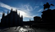 People walk in Duomo square as the region of Lombardy becomes a 'red zone', going into lockdown as the country struggles to reduce the coronavirus disease (COVID-19) infections, in Milan, Italy, March 15, 2021. REUTERS/Flavio Lo Scalzo