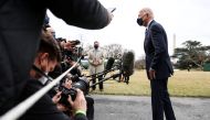 U.S. President Joe Biden talks to reporters as he departs for travel to Pennsylvania to promote the 