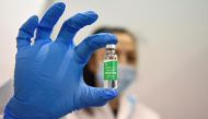 A medical worker holds a vial of the AstraZeneca vaccine against the coronavirus disease (COVID-19), during the country's mass vaccination program, in Belgrade, Serbia, March 16, 2021. REUTERS/Zorana Jevtic