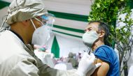 FILE PHOTO: A man reacts while receiving his first dose of China's Sinovac Biotech vaccine for the coronavirus disease (COVID-19) during the mass vaccination program for elderly people at Indonesia's health ministry in Jakarta, Indonesia, March 2, 2021. R