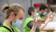 Medical workers prepare doses of Oxford/AstraZeneca's COVID-19 vaccine at a vaccination centre in Antwerp, Belgium March 18, 2021. REUTERS/Yves Herman
