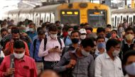 People wearing protective masks walk on a platform at the Chhatrapati Shivaji Terminus railway station, amidst the spread of the coronavirus disease (COVID-19), in Mumbai, India, March 16, 2021. REUTERS/Niharika Kulkarni
