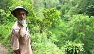 Sadiman, a 69-year-old ecowarrior, stands near a hill which is the first area he replanted with trees 20 years ago, in Wonogiri, Central Java province, Indonesia, in this still taken from March 13, 2021 video. Stringer/REUTERS TV via REUTERS