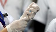 A healthcare worker fills a syringe with a dose of Bharat Biotech's COVID-19 vaccine called COVAXIN, during the coronavirus disease (COVID-19) vaccination campaign at All India Institute of Medical Sciences (AIIMS) hospital in New Delhi, India, January 16