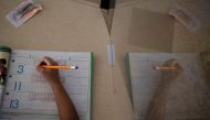 A student writes after returning to school as coronavirus disease (COVID-19) restrictions are lifted in Philadelphia, Pennsylvania, U.S., March 8, 2021. REUTERS/Hannah Beier/File Photo