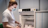 File photo: Staff member handles AstraZeneca COVID-19 vaccines in storage at Region Hovedstaden's Vaccine Center, Copenhagen, Denmark February 11, 2021. Ritzau Scanpix/Liselotte Sabroe via Reuters 