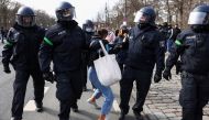 Police officers detain a demonstrator during a right-wing rally against the government's restrictions following the coronavirus disease (COVID-19) outbreak in Berlin, Germany, March 20, 2021. REUTERS/Christian Mang