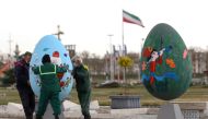 Municipality personnel carry Nowruz-themed decorations, ahead of Nowruz, the Iranian New Year, amid the coronavirus disease (COVID-19) pandemic, in Tehran, Iran March 17, 2021. Picture taken March 17, 2021. Majid Asgaripour/WANA