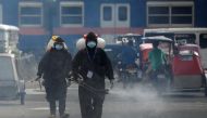 Workers in hazmat suits disinfect a street as a preventive measure against the spread of coronavirus disease (COVID-19) at a village in Manila, Philippines, March 19, 2021. REUTERS/Lisa Marie David
