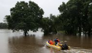 State Emergency Service personnel transport a dentist by boat from the suburb of Windsor to North Richmond across floodwaters, so he can attend to patients unreachable by car, as the state of New South Wales experiences widespread flooding and severe weat