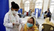 A resident receives a dose of coronavirus disease (COVID-19) vaccine, at a vaccination center in Karachi, Pakistan March 22, 2021. REUTERS/Akhtar Soomro
