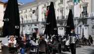 A street musician performs at the terrace of a restaurant, amid the coronavirus disease (COVID-19) pandemic, in Madrid, Spain, March 22, 2021. REUTERS/Susana Vera

