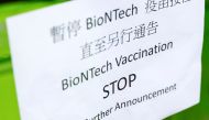 A sign is seen outside a vaccination centre after Hong Kong temporarily suspended coronavirus disease (COVID-19) vaccine from a single batch of Pfizer/BioNTech shots due to packaging defects, in Hong Kong, China March 24, 2021. REUTERS/Tyrone Siu