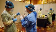 Medical workers are seen at a coronavirus disease (COVID-19) rapid antigen test center at Geo Connect Asia trade conference in Singapore March 24, 2021. REUTERS/Edgar Su