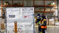 FedEx employees unload a shipment from Europe of the Moderna vaccine against the coronavirus disease (COVID-19) at Toronto Pearson Airport in Mississauga, Ontario, Canada March 24, 2021. REUTERS/Carlos Osorio
