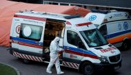A paramedic walks near an ambulance amid the coronavirus disease (COVID-19) outbreak, in front of a hospital in Warsaw, Poland December 3, 2020. REUTERS/Kacper Pempel/File Photo