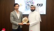 Ali Al Malki, Secretary-General of Qatar Basketball Federation, presenting a memento to Ignacio Soriano, Head of Events and Partnerships at FIBA, during a press conference held in Doha yesterday