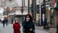People wearing protective face masks walk in downtown Budapest, after Hungarian government imposed a nationwide lockdown to contain the spread of the coronavirus disease (COVID-19), Hungary, November 11, 2020. REUTERS/Bernadett Szabo/Files/File Photo