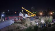 People inspect the damage after two trains have collided near the city of Sohag, Egypt, March 26, 2021. Picture taken March 26, 2021 REUTERS/Meritt Elsayed Ali