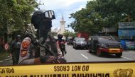 Armed police officers stand guard along a closed road following an explosion outside a Catholic church in Makassar, South Sulawesi province, Indonesia, March 28, 2021 in this photo taken by Antara Foto. Antara Foto/Arnas Padda/ via REUTERS 