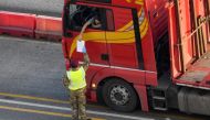 A military officer checks documents as a lorry driver waits to enter the Port of Dover in preparation for crossing the channel to France, following the coronavirus disease (COVID-19) outbreak, in Dover, Britain December 31, 2020. REUTERS/Toby Melville/Fil