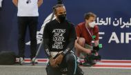 Formula One F1 - Bahrain Grand Prix - Bahrain International Circuit, Sakhir, Bahrain - March 28, 2021 Mercedes' Lewis Hamilton kneels in support of the Black Lives Matter campaign on the grid before the race REUTERS/Hamad I Mohammed
