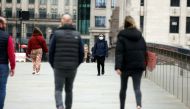People socially distance while walking across London Bridge as coronavirus disease (COVID-19) lockdown restrictions begin to ease, allowing groups of 6 to meet up outside starting from March 29, in London, Britain, March 28, 2021. REUTERS/Kevin Coombs/Fil