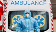 A medical worker wearing protective gear stands next to an ambulance outside a hospital for patients infected with COVID-19 in Kyiv, Ukraine, November 24, 2020. REUTERS/Gleb Garanich/File Photo