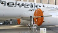 A robot developed by Swiss company UVeya armed with virus-killing ultraviolet light is seen in front of an Embraer airplane of Helvetic Airways, as the spread of the coronavirus disease (COVID-19) continues, at Zurich Airport in Zurich, Switzerland March 