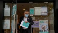 A man wearing a face mask leaves a vaccination centre administering COVID-19 vaccine, in Hong Kong, China March 23, 2021. REUTERS/Lam Yik/File Photo