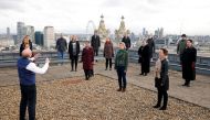 The choir of London's Royal Opera House perform on the rooftop of the Royal Opera House to celebrate Good Friday and the arrival of spring in London, Britain, March 25, 2021. Picture taken March 25, 2021. REUTERS/John Sibley